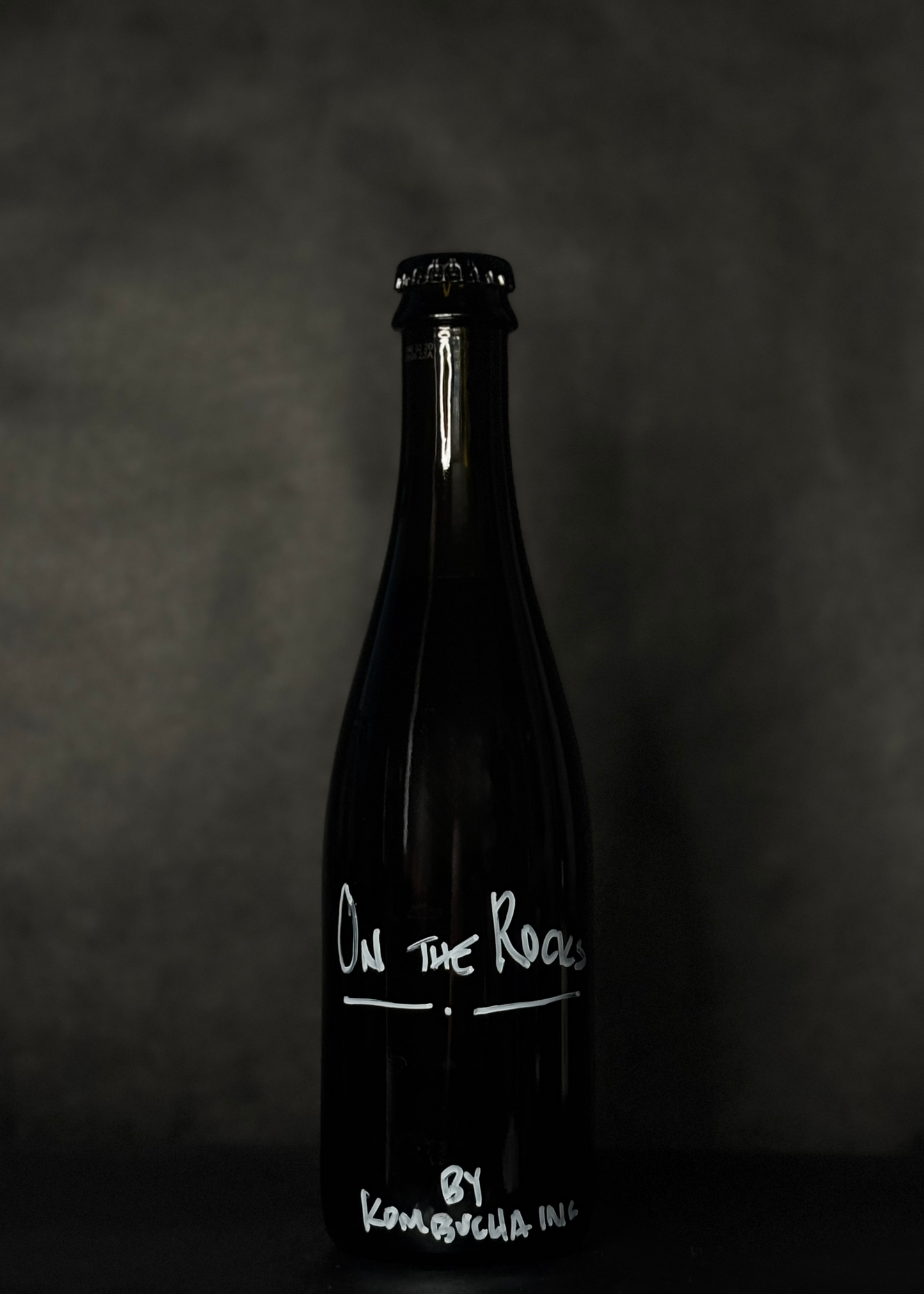 Kombucha Inc. On the Rocks, a low-alcohol whiskey-aged kombucha with rich coffee notes, offering a bold and unique drinking experience. Crafted with high-quality ingredients, this fermented beverage combines the depth of whiskey aging with the richness of coffee for a sophisticated and distinct flavor