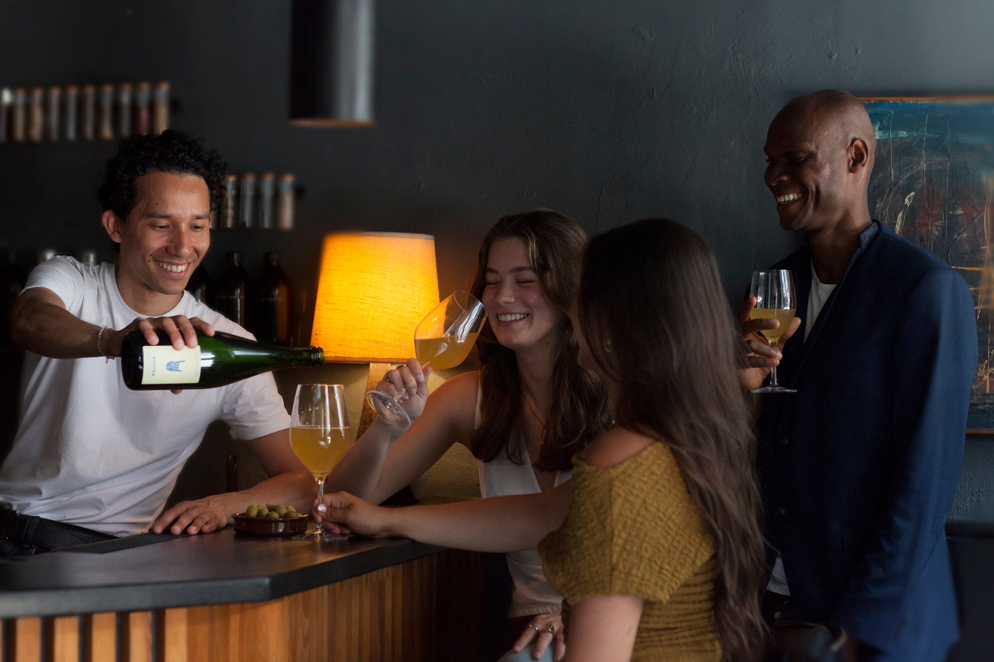 Group of friends gets another round of kombucha with yuzu in a copenhagen bar.