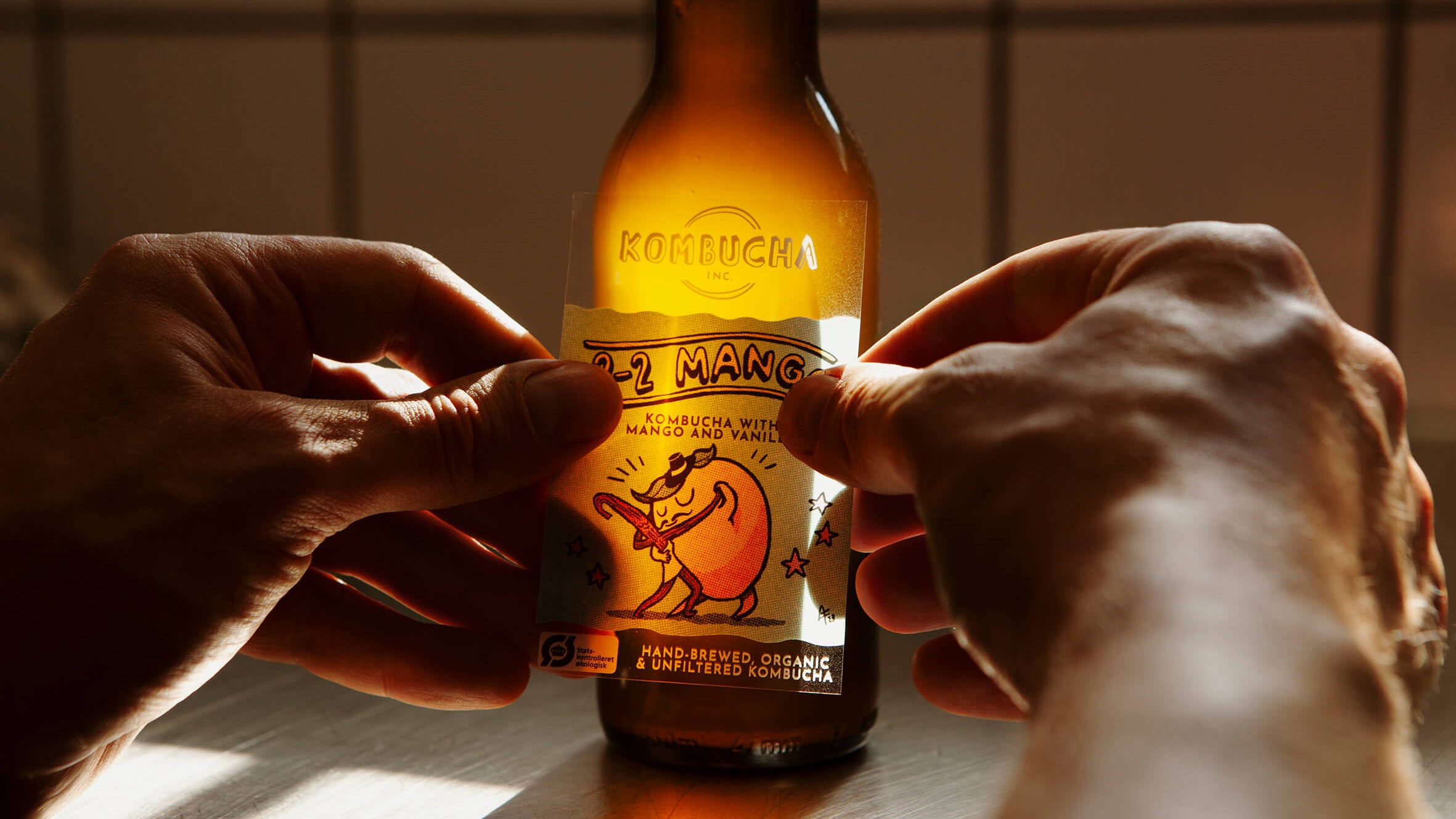Kombucha Inc. mango-flavored kombucha with playful illustrated labels, crafted in Copenhagen’s Meatpacking district, offering a unique non-alcoholic craft beer alternative made with organic ingredients.